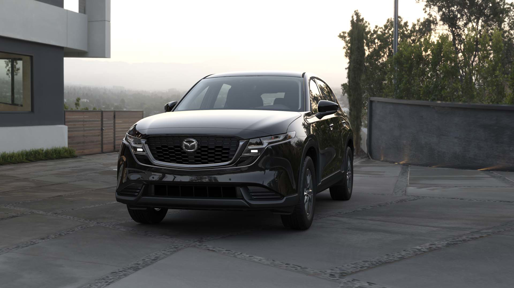 Стильный кроссовер Mazda CX-5 следующего поколения в фирменном красном цвете Soul Red на фоне горного серпантина.