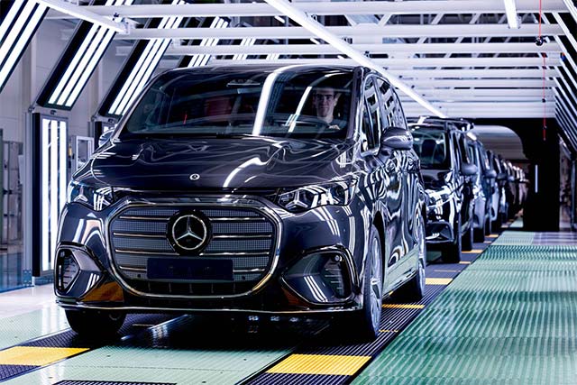 Роскошный электрический минивэн Mercedes-Benz VLE серебристого цвета выезжает из ворот завода в Испании.